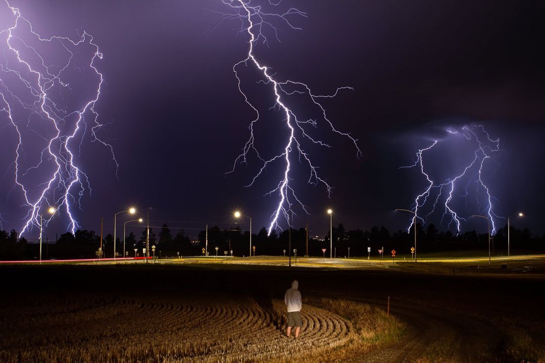 Three lightning strikes over the Montana prairie at night